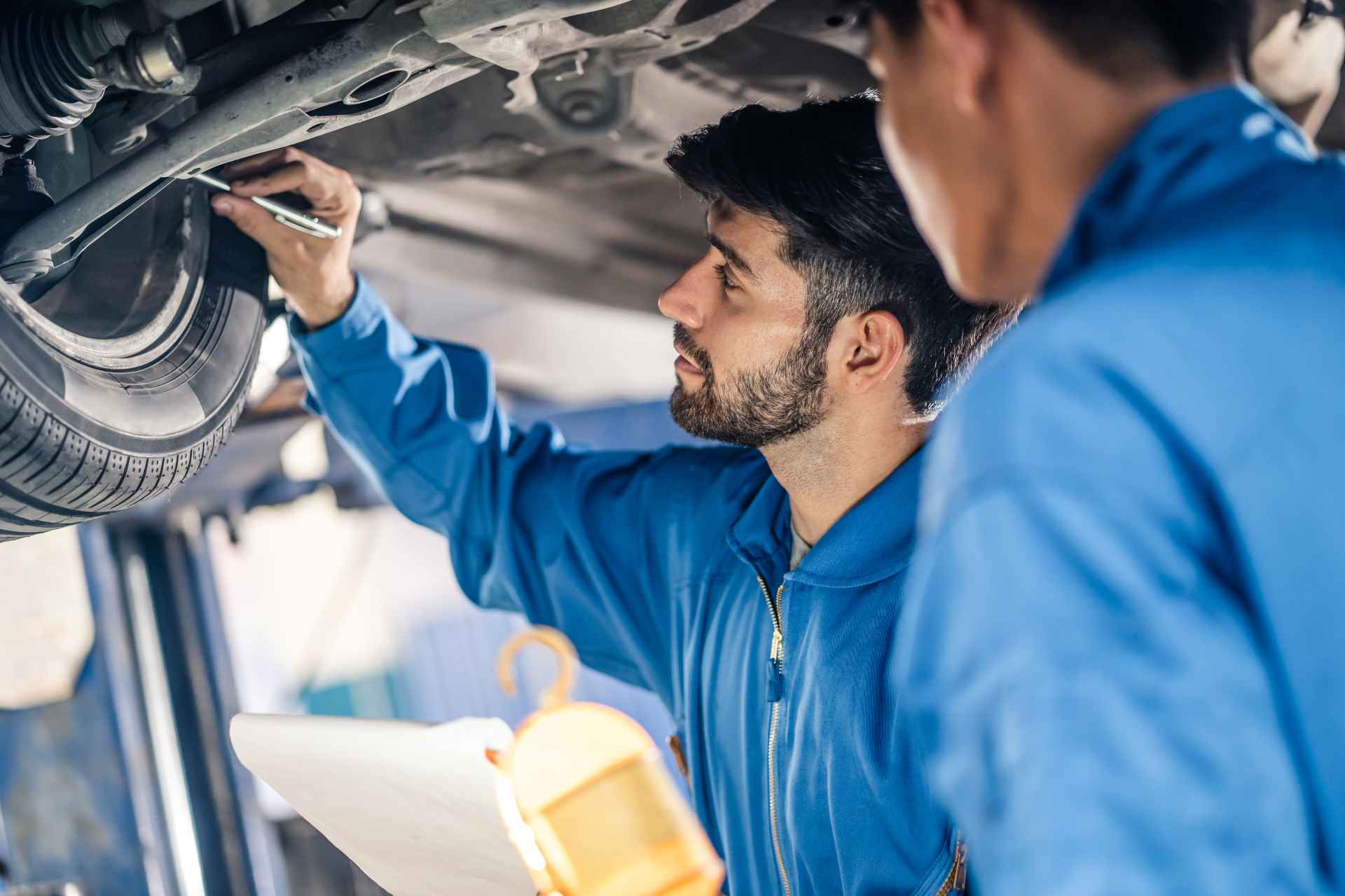 get more customers to your garage; a mechanic talking to a customer
