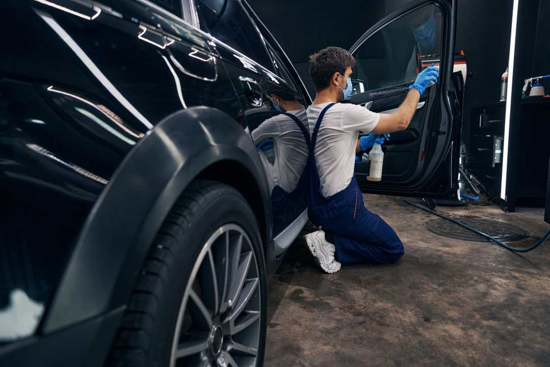 manage bookings, a car technician working on a car