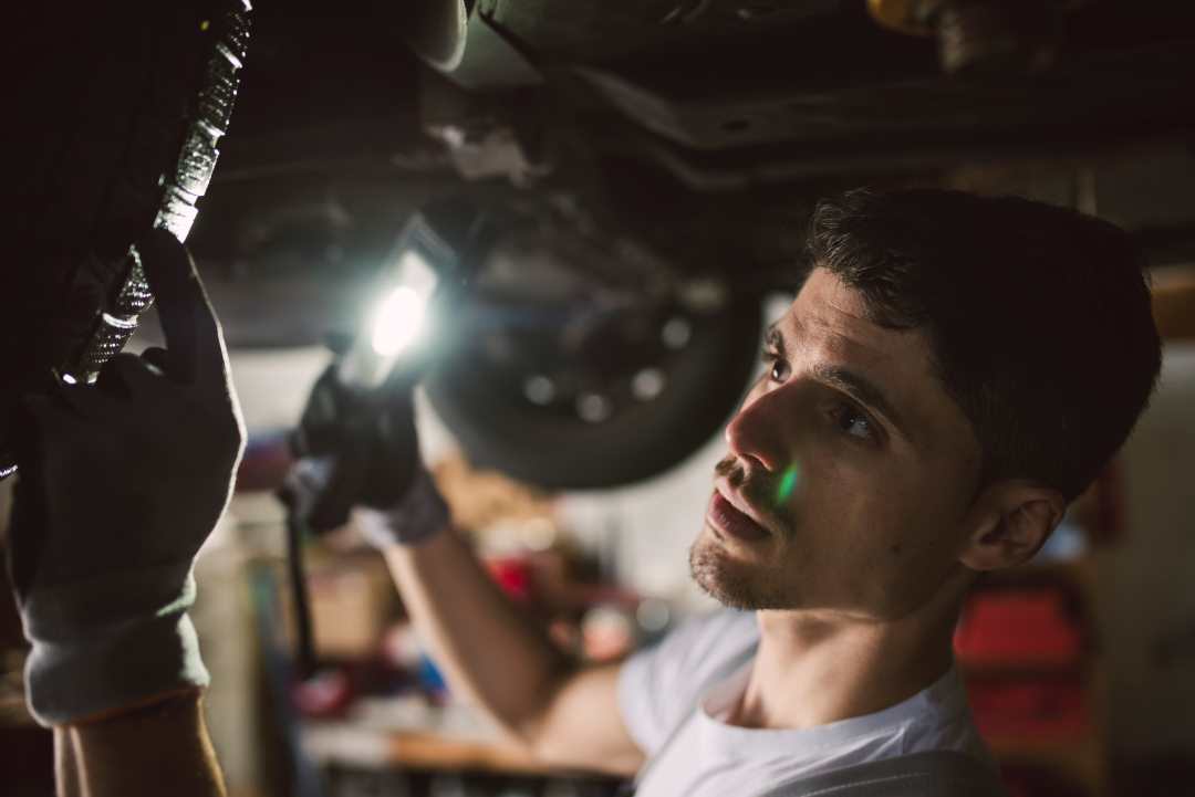 car repairs, a car technician inspecting a car