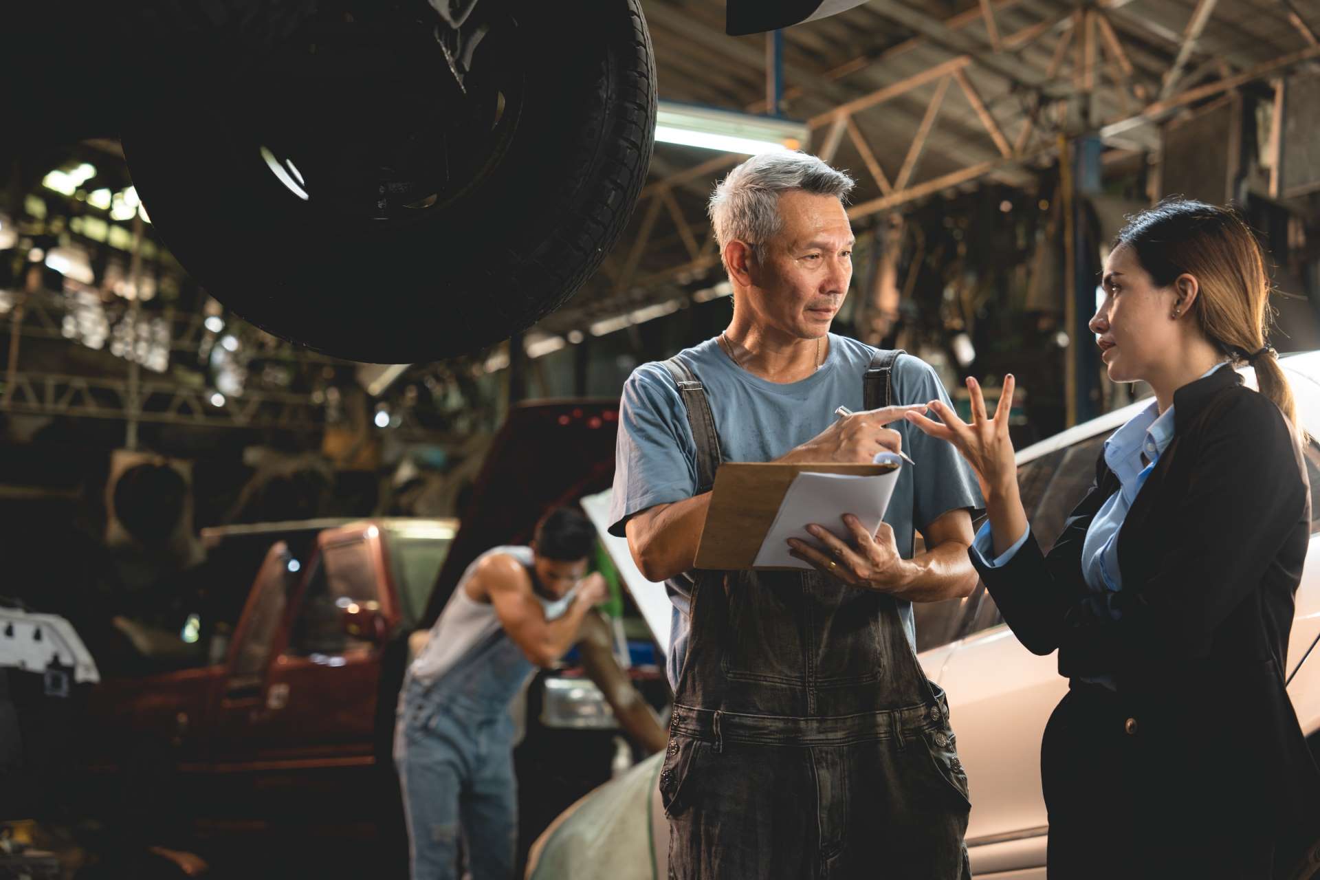 personnel-management, a garage owner helping a client out with their queries