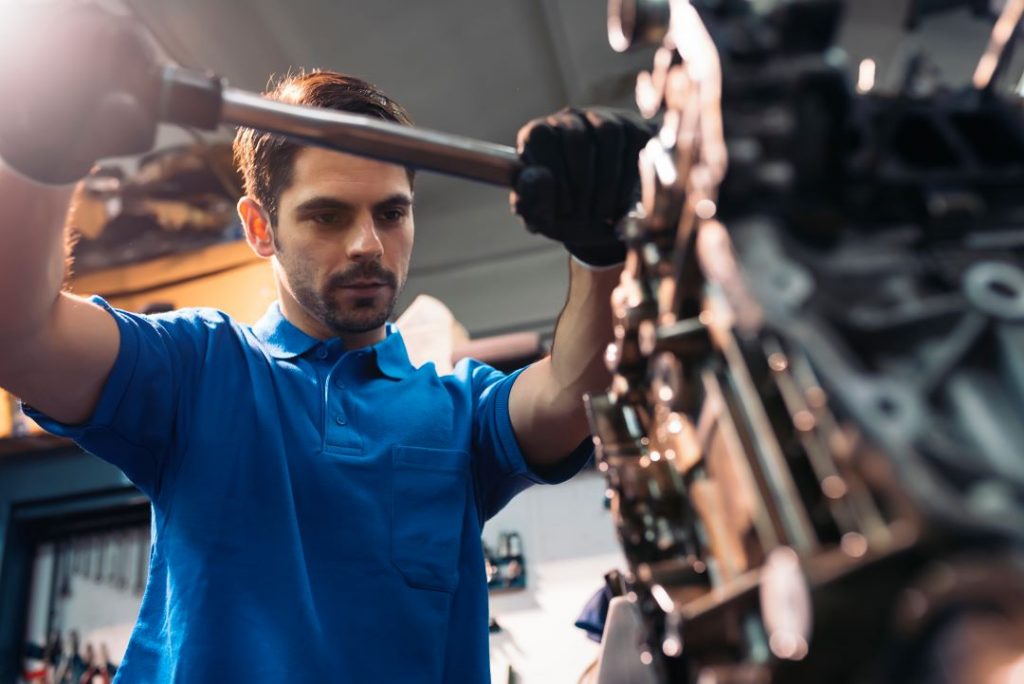 increase employee productivity, a car technician working on a repair job
