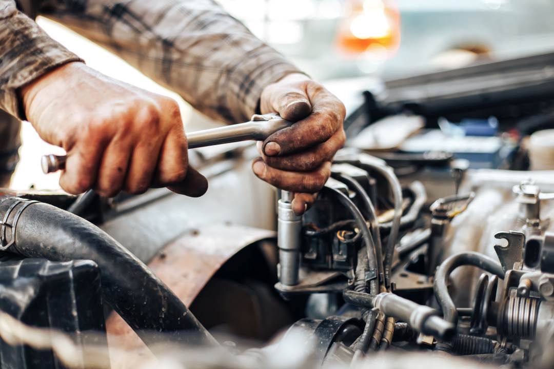 car repair estimate, a car technician working on a car