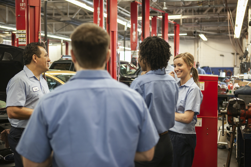 Busy garage, garage employees talking.