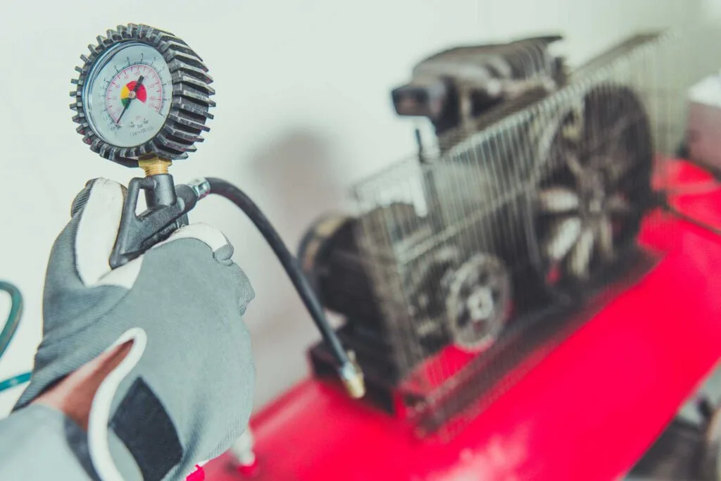 modern garage design, mechanic using air compressor tool