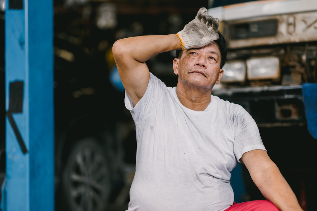 Disadvantages of seasonal work, an exhausted garage employee.