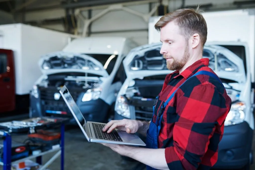 better customer service, mechanic browsing a laptop to track customer scheduling